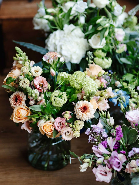 Bouquet of flowers in a vase on a wooden surface